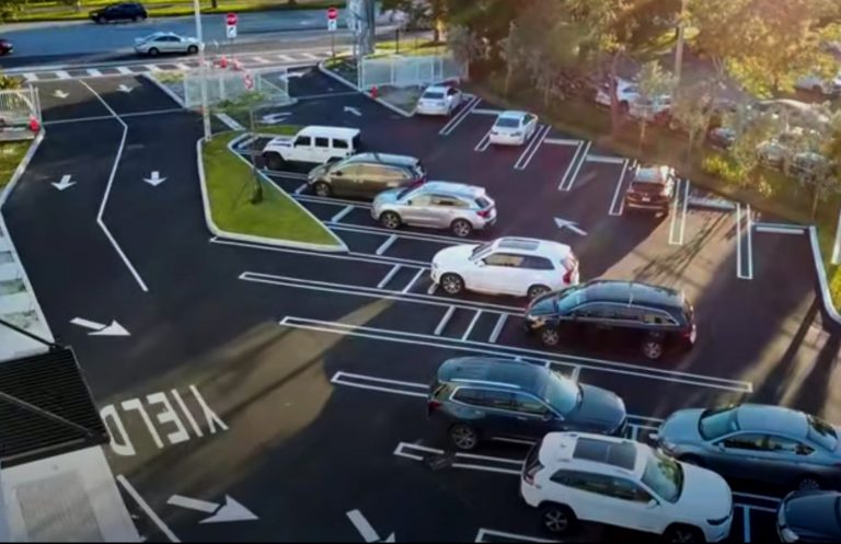 Cars in a parking lot with road signage
